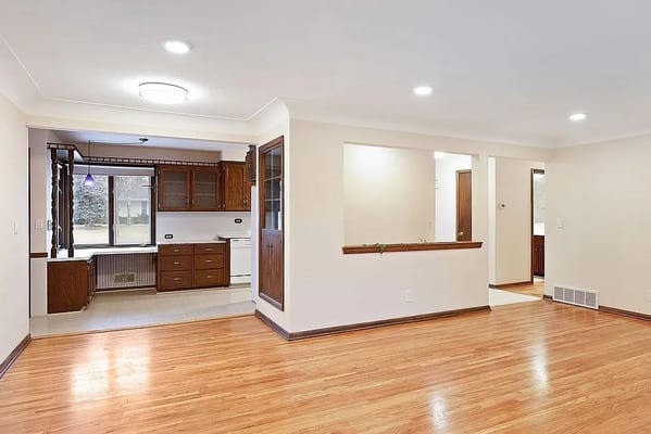 View of open kitchen and living area with hardwood floors