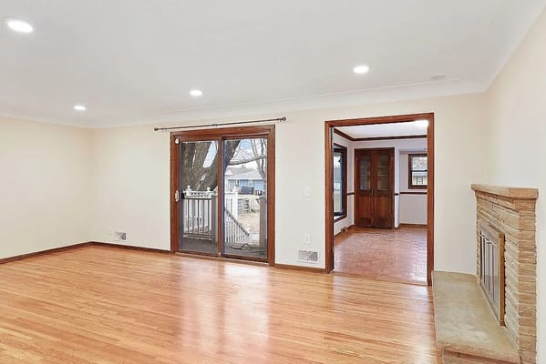 Bright living room with wooden floors and sliding doors