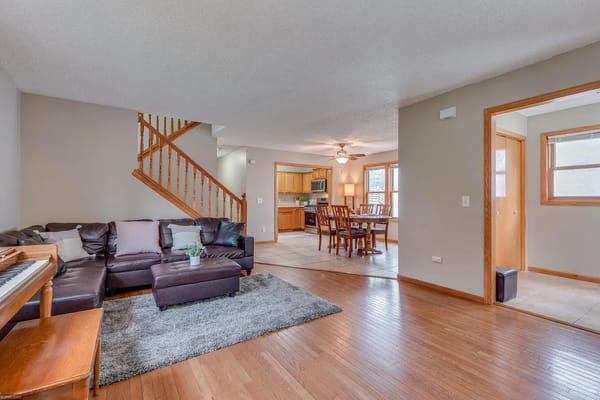 Spacious living area with a sofa, coffee table, and dining area