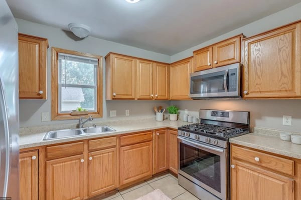 Modern kitchen with wooden cabinets and stainless steel appliances