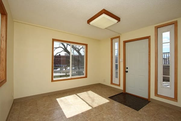 Sunlit living area with large windows and a door