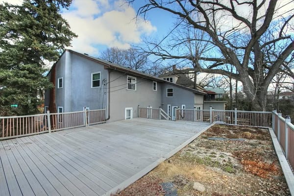 Spacious outdoor deck area with trees in the background