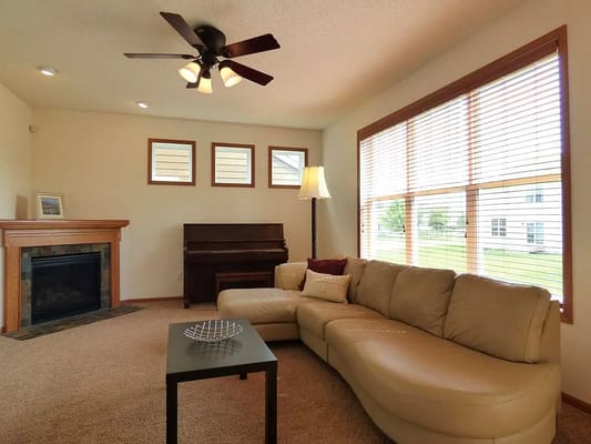 Cozy living area with a couch and piano