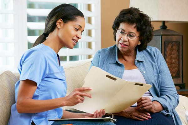 Caregiver assisting a resident in a cozy interior setting