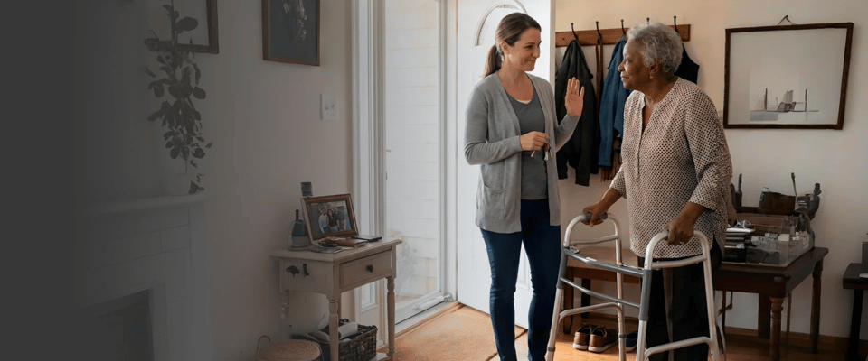Caregiver assisting an elderly woman in a cozy interior