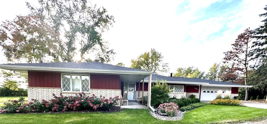 Exterior view of a red and white assisted living facility