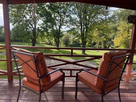 Seating area overlooking a lush green landscape