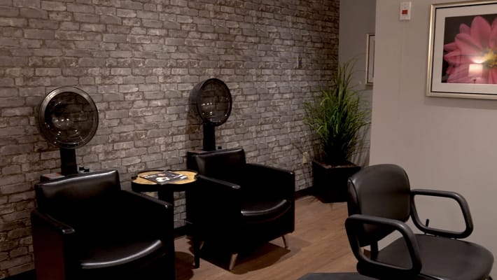 Hair salon area with seating and hair dryers