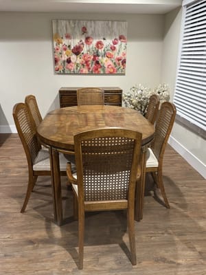 Interior common area with a dining table and floral artwork