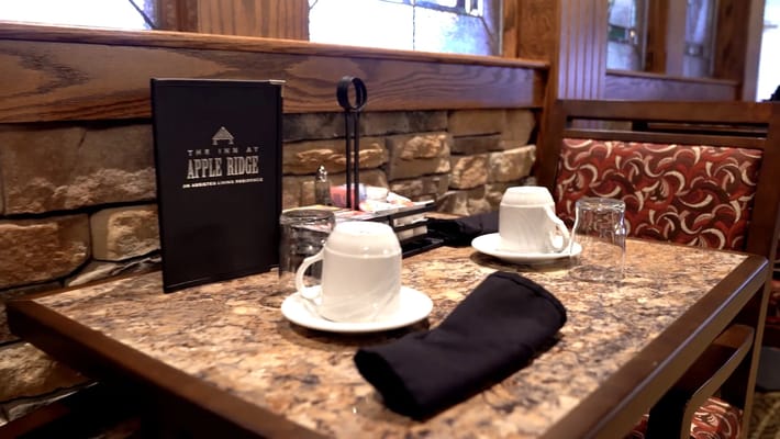 Dining setup with cups and table menu at Apple Ridge