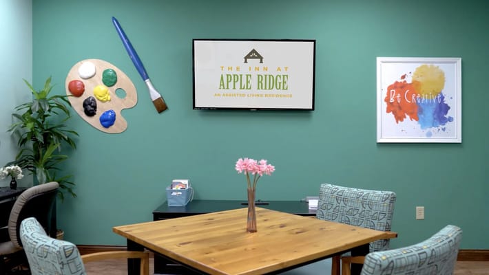 Creatively decorated common area with a table and art supplies