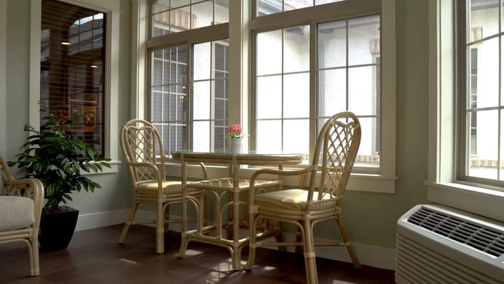 Cozy seating area with a table and chairs by a large window
