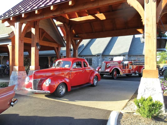 Classic cars entering the assisted living facility entrance