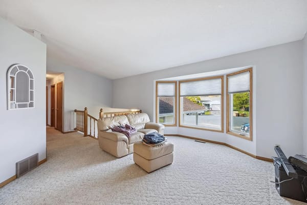 Spacious living room with a couch and large windows