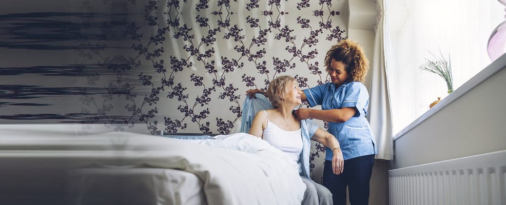 Caregiver assisting a resident in a cozy room