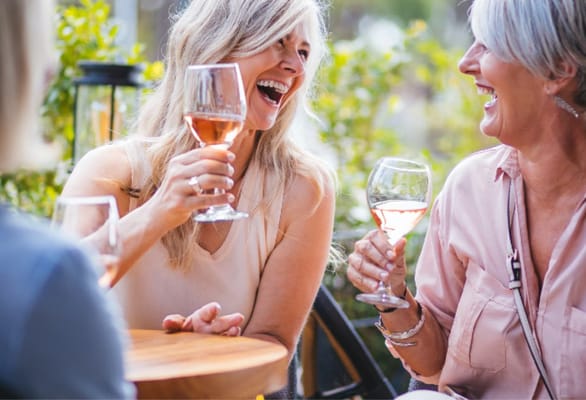 Residents enjoying drinks and laughter outdoors