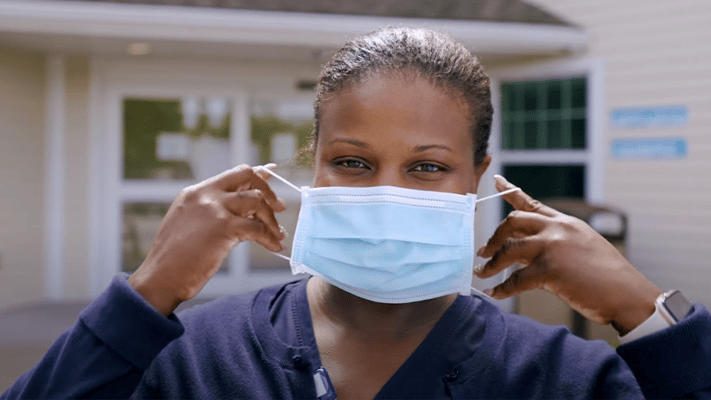 Staff member wearing a mask outside the facility