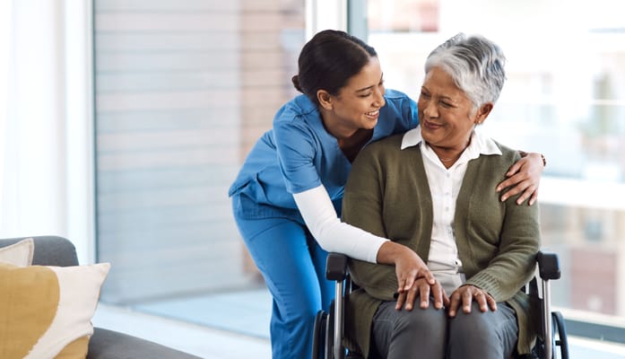 A caregiver and a resident sharing a moment indoors