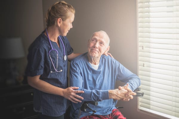 A caregiver interacting with a resident in a cozy room