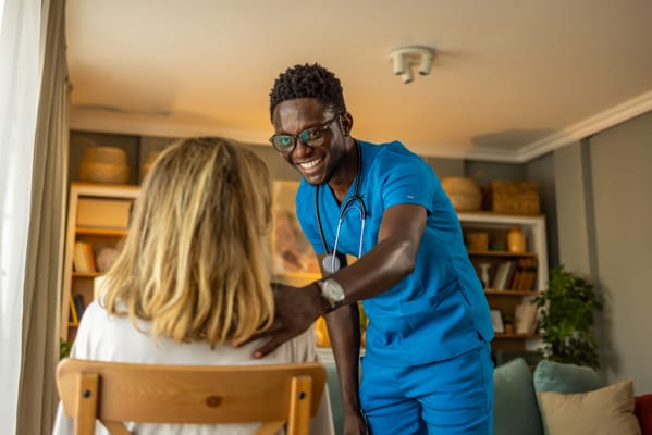 A nurse interacting with a resident in a cozy common area