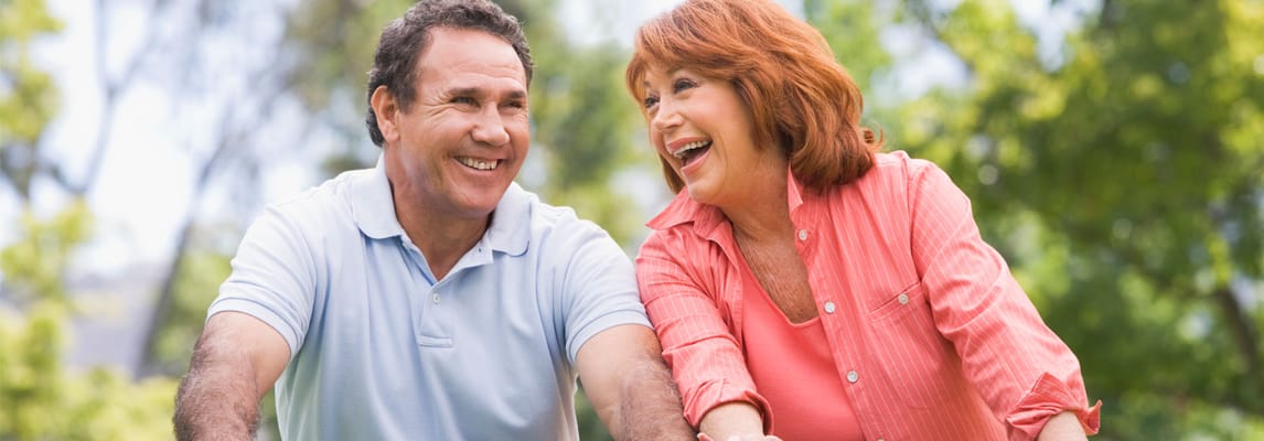 Two smiling seniors enjoying time outdoors