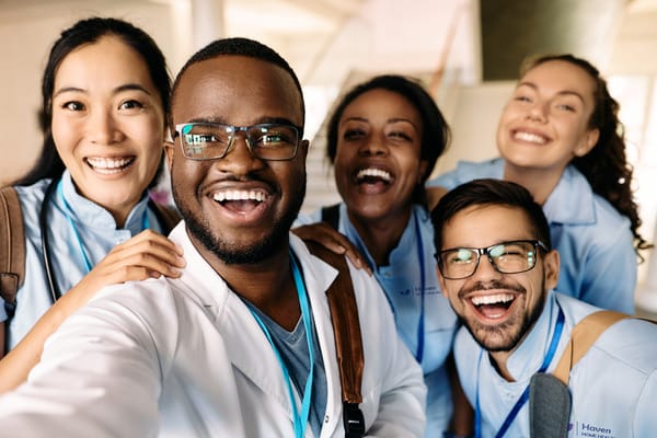 Staff members smiling and posing together indoors