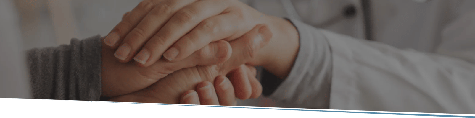 Hands of a caregiver and a resident in a comforting gesture