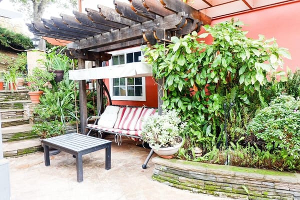 Seating area with a swing and plants on a patio