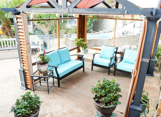 Comfortable seating area in courtyard with potted plants