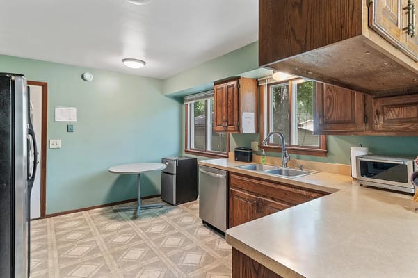 A kitchen area with countertop and appliances