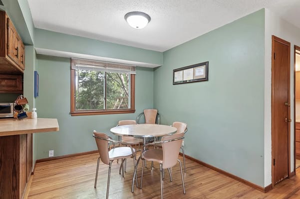 Brightly lit interior room with a table and chairs