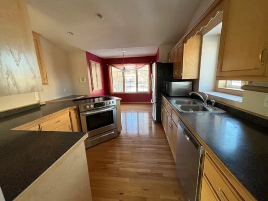 Modern kitchen with wooden cabinets and appliances