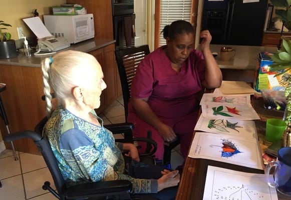 Resident and staff engaged in an art activity
