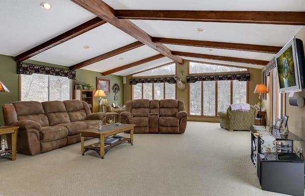 Spacious living room with comfortable seating and large windows