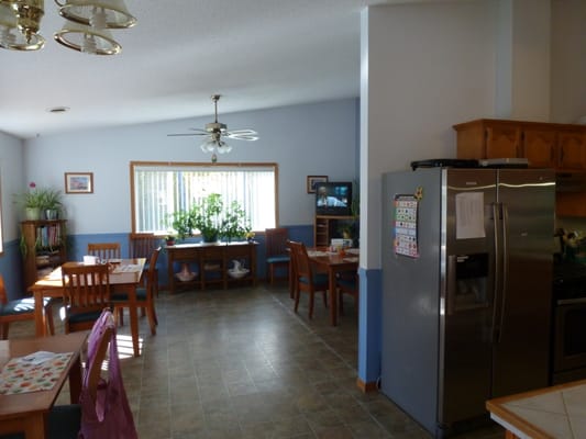 Bright dining area with wooden tables and plants