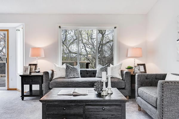 A cozy living room featuring gray sofas and a wooden coffee table.