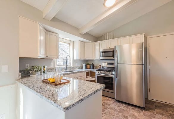 Spacious kitchen with stainless steel appliances and granite countertops