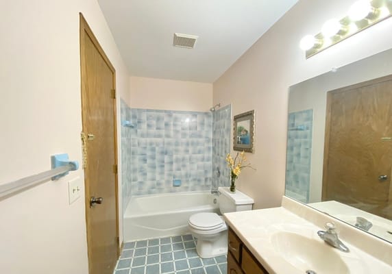 Bright bathroom featuring a shower tub and sink