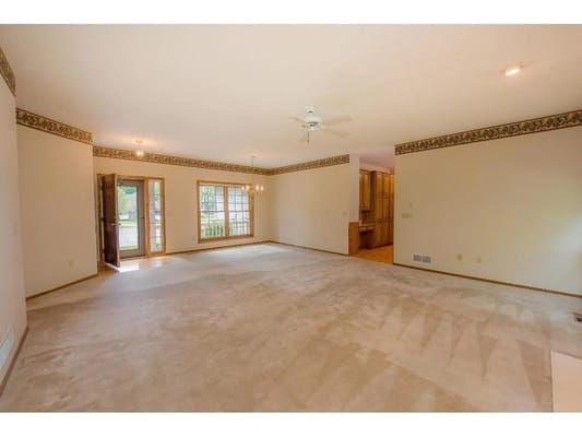 Spacious living room with carpet and light fixtures