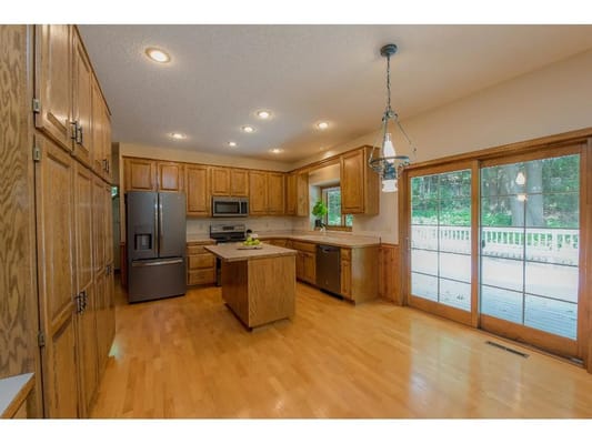 Bright and spacious kitchen with wooden cabinets and appliances