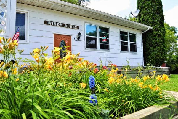 Front entrance of Windy Acres with flowers in the foreground