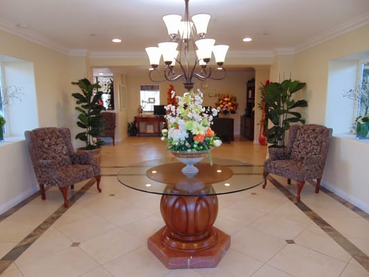 Interior view of a lobby with seating and flowers