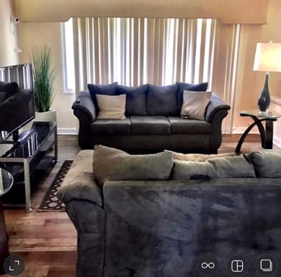 Living room with couches and light curtains