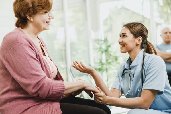 Nurse interacting with a resident in a bright indoor setting