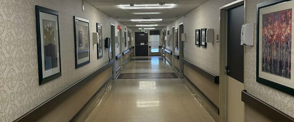 Brightly lit hallway with framed artwork