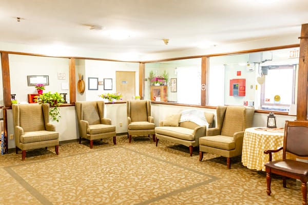 A cozy living room with beige armchairs and a small table