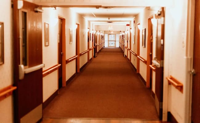 Interior hallway with artwork and wooden railings