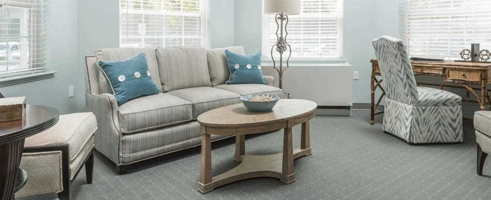 Inviting living room with a sofa, armchair, and desk