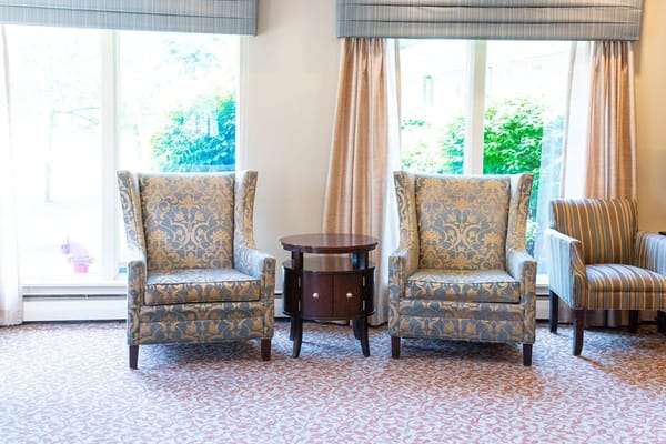 Two armchairs and a small table in a living room