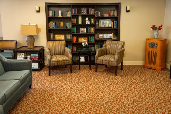Comfortable seating area with bookshelves and vintage decor